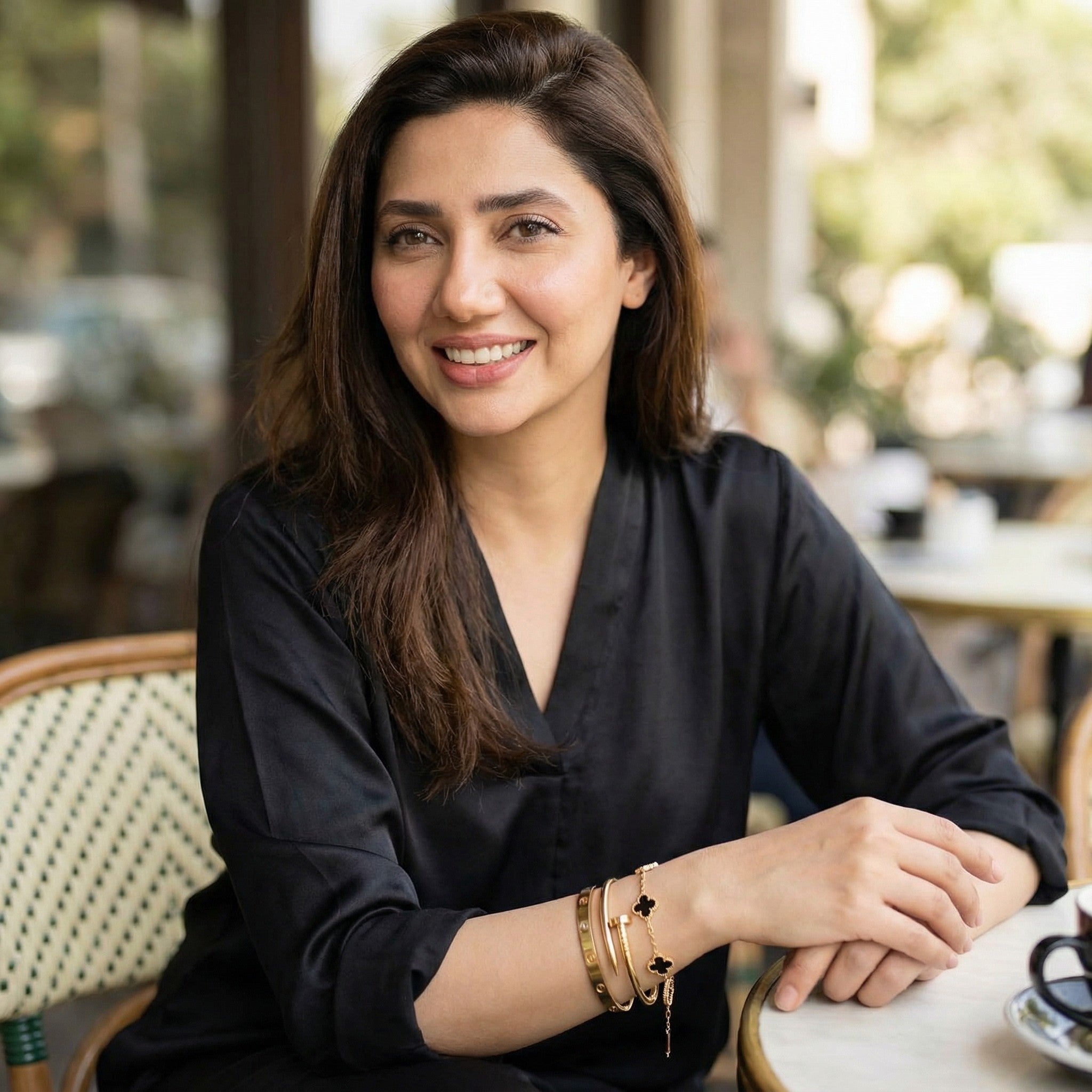 Woman sitting at a table in an outdoor cafe setting